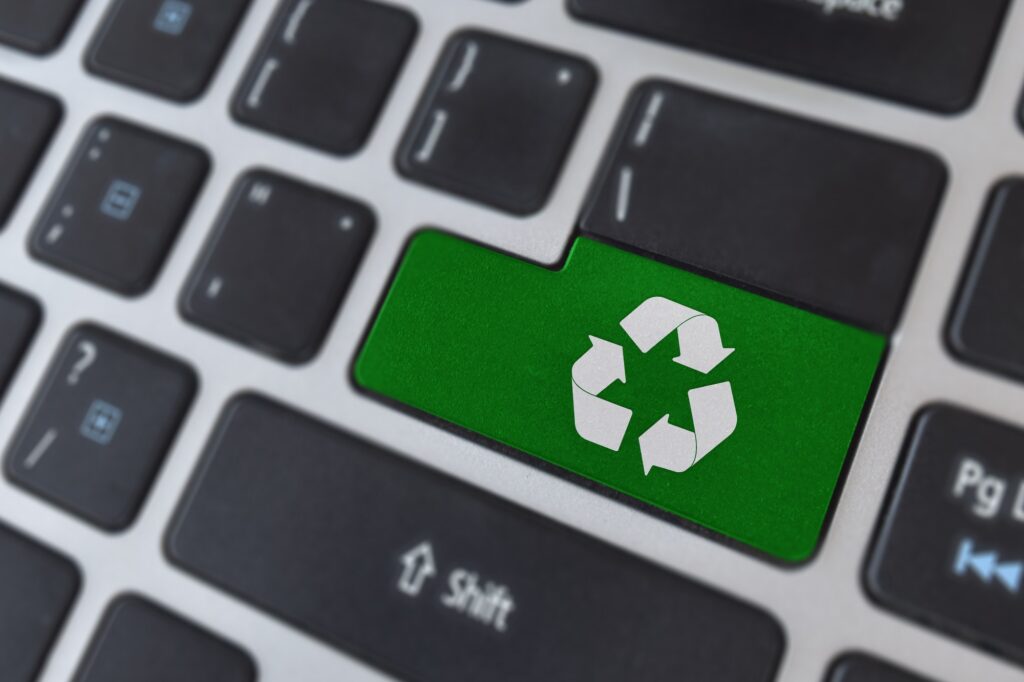 Save of environment concept. Logo recycle icon symbol on laptop keyboard.