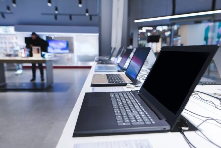 Laptops on the table in the electronics store. The department of laptops in the tech store. Buy a laptop.